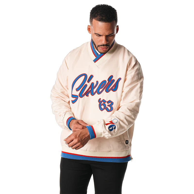 Pull coupe-vent unisexe The Wild Collective à appliqués Philadelphia 76ers de couleur crème