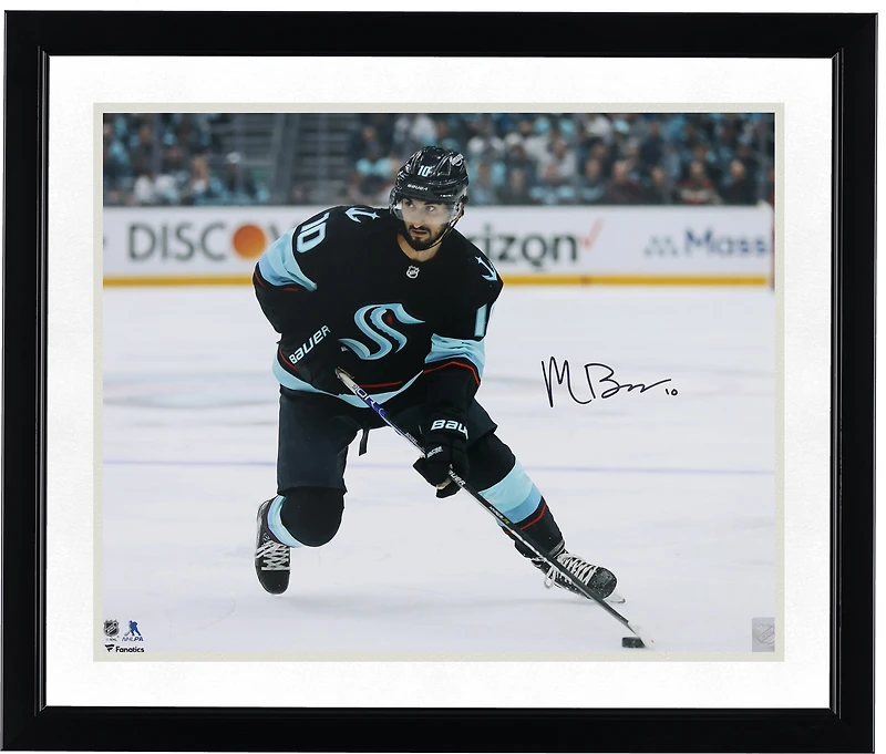 Matty Beniers Seattle Kraken Autographed 16" x 20" Navy Jersey with Puck Photograph