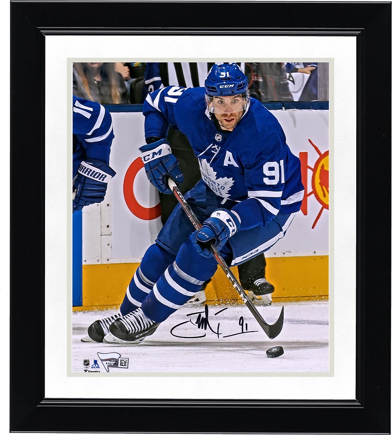 John Tavares Toronto Maple Leafs Autographed 8" x 10" Blue Jersey Skating with Puck Vertical Photograph