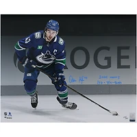 Quinn Hughes Vancouver Canucks Autographed 16" x 20" Blue Jersey Spotlight Photograph with "2024 Norris" & "17G - 75A - 92 Pts" Inscriptions