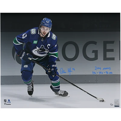 Quinn Hughes Vancouver Canucks Autographed 16" x 20" Blue Jersey Spotlight Photograph with "2024 Norris" & "17G - 75A - 92 Pts" Inscriptions - Limited Edition of 24