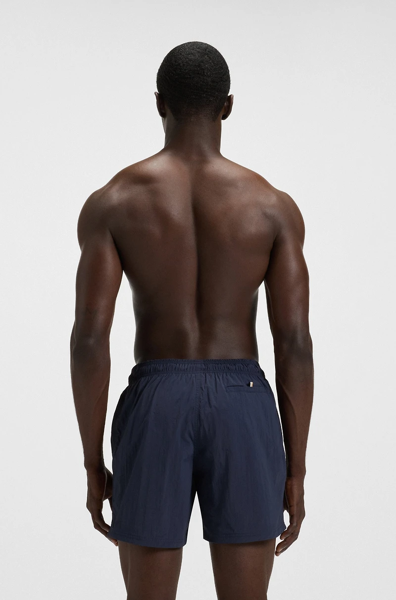 Swim shorts with vertical logo print