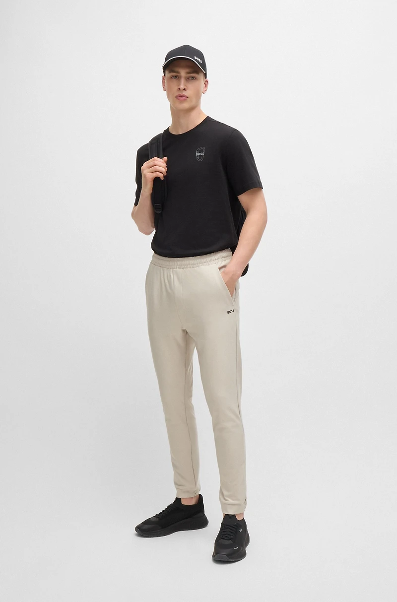 Tracksuit bottoms stretch fabric with decorative reflective logo