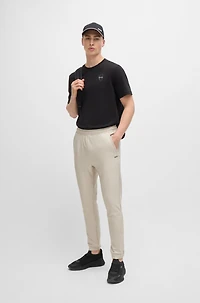 Tracksuit bottoms stretch fabric with decorative reflective logo