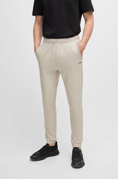 Tracksuit bottoms stretch fabric with decorative reflective logo