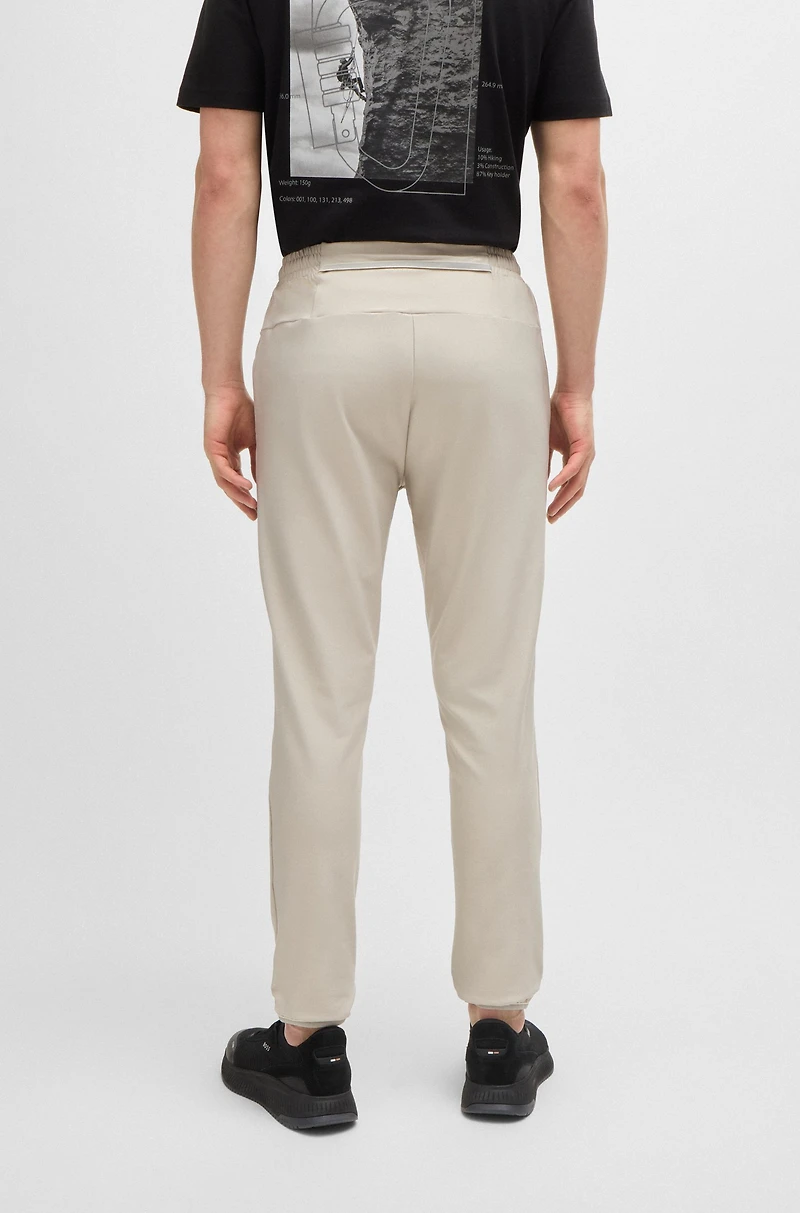 Tracksuit bottoms stretch fabric with decorative reflective logo