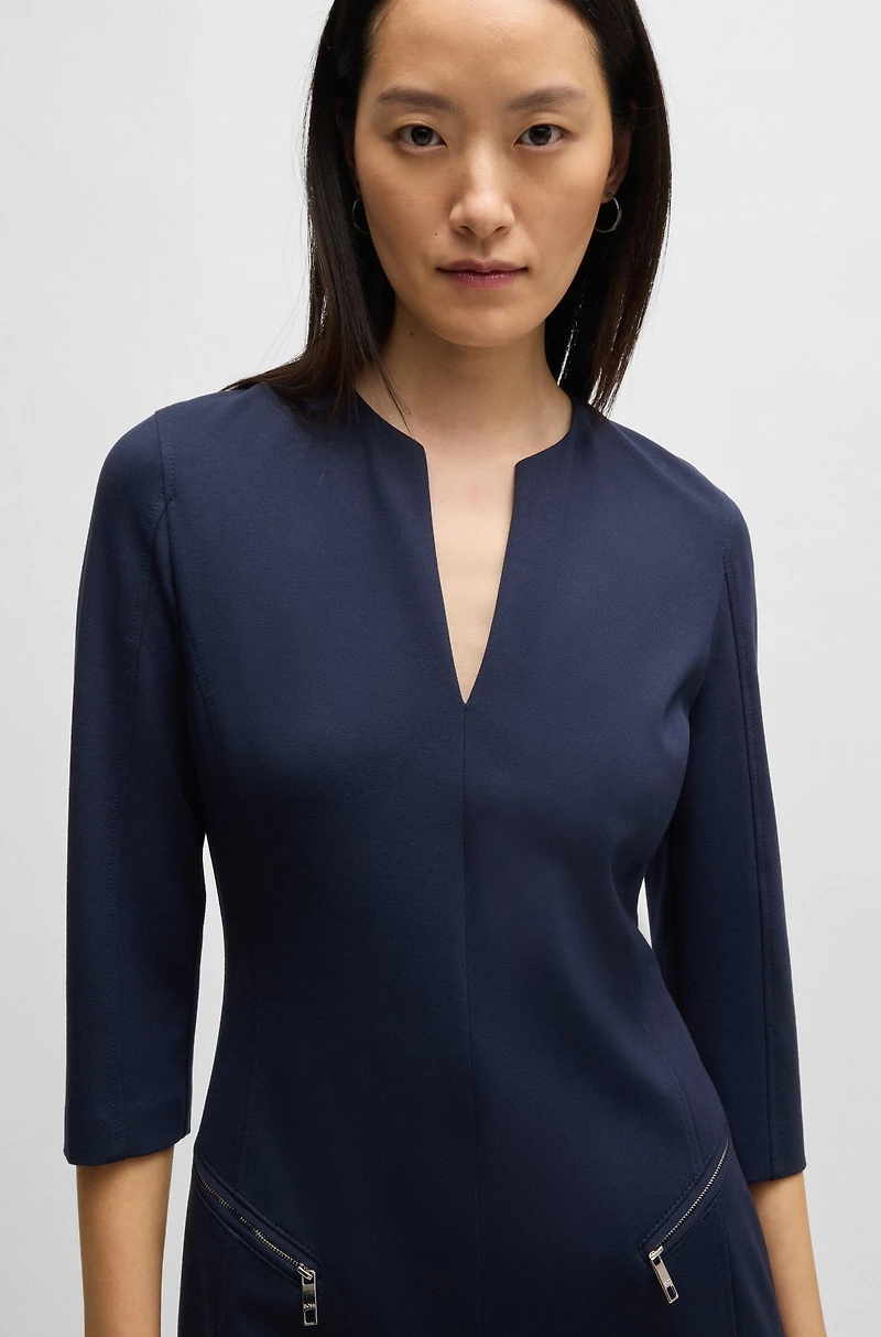 V-neck dress with zipped pockets and cropped sleeves