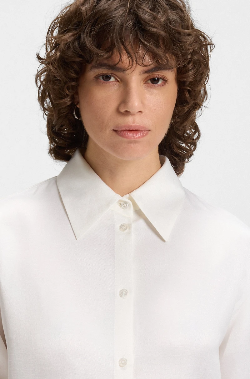 Tailored blouse with crochet-effect trims