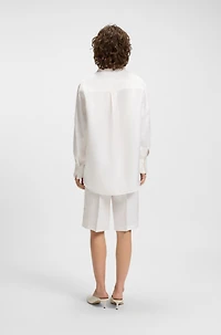 Tailored blouse with crochet-effect trims