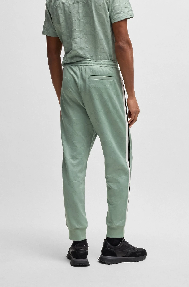 Relaxed-fit tracksuit bottoms with jacquard-woven circles