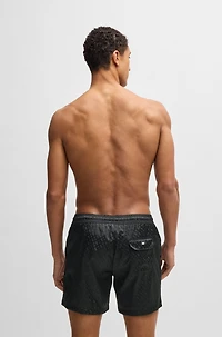Swim shorts with all-over tonal monograms