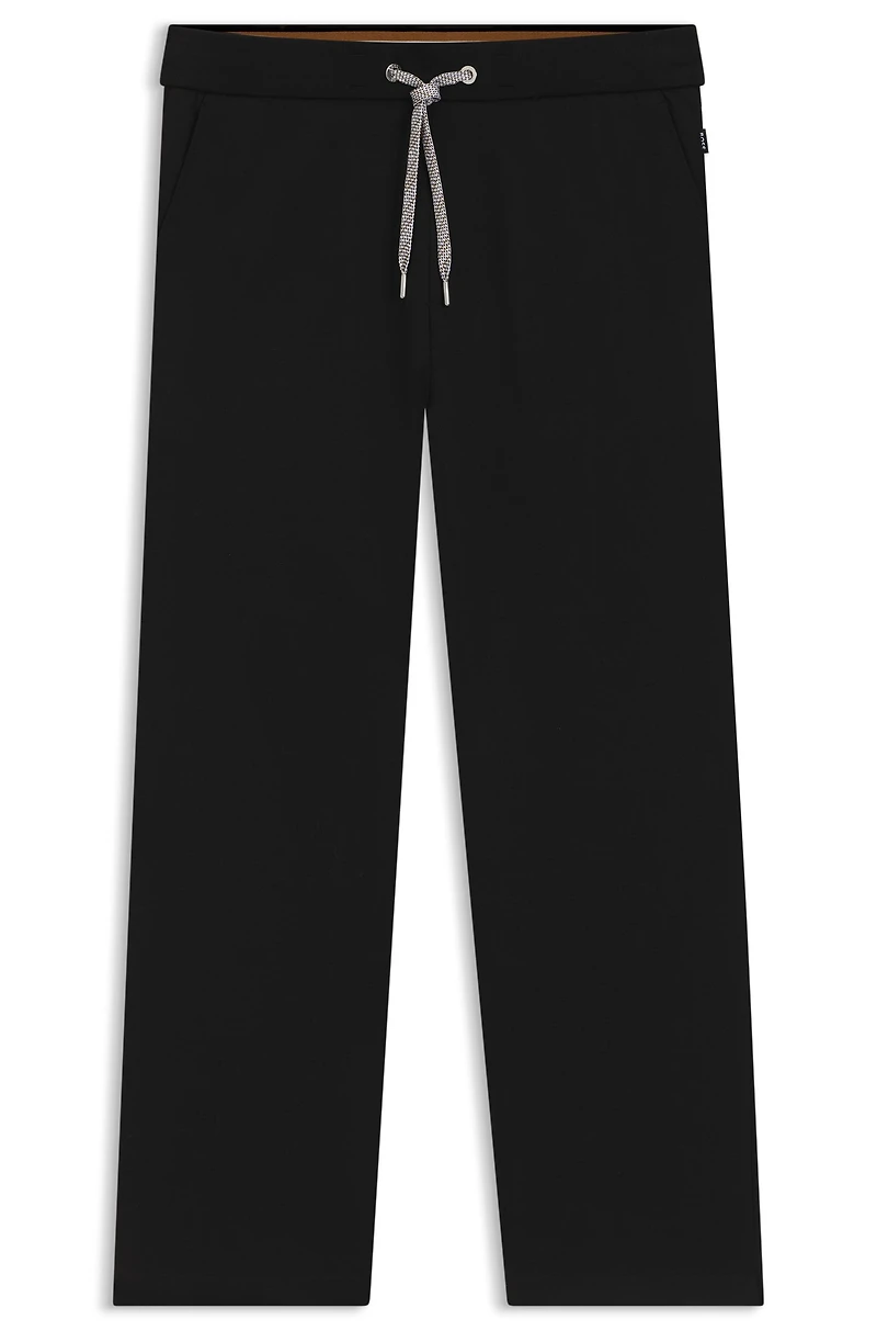 Tracksuit bottoms with patterned drawcord