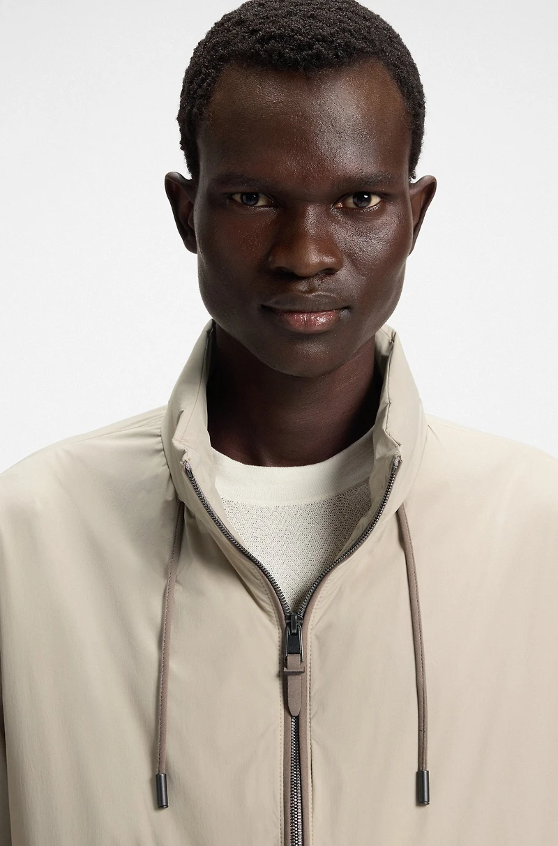 Water-repellent windbreaker with packable hood