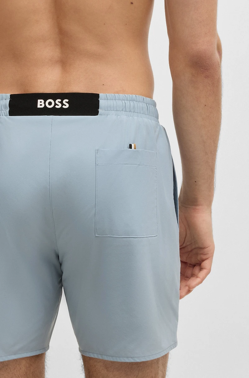 Swim shorts with rubber logo badge