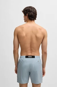 Swim shorts with rubber logo badge