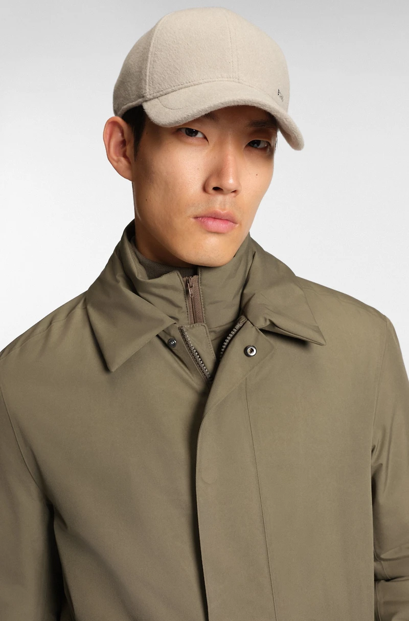 Water-repellent coat with detachable bib