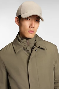 Water-repellent coat with detachable bib