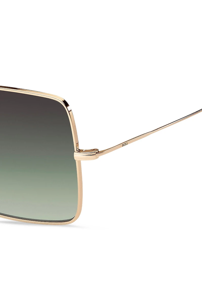Gold-tone sunglasses with green end-tips
