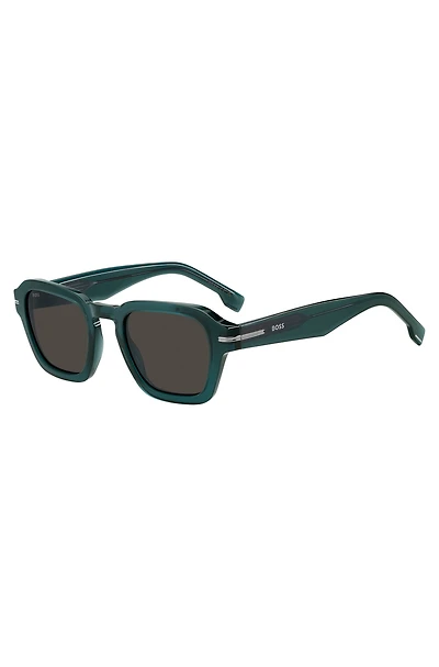 Green acetate sunglasses with temple logo