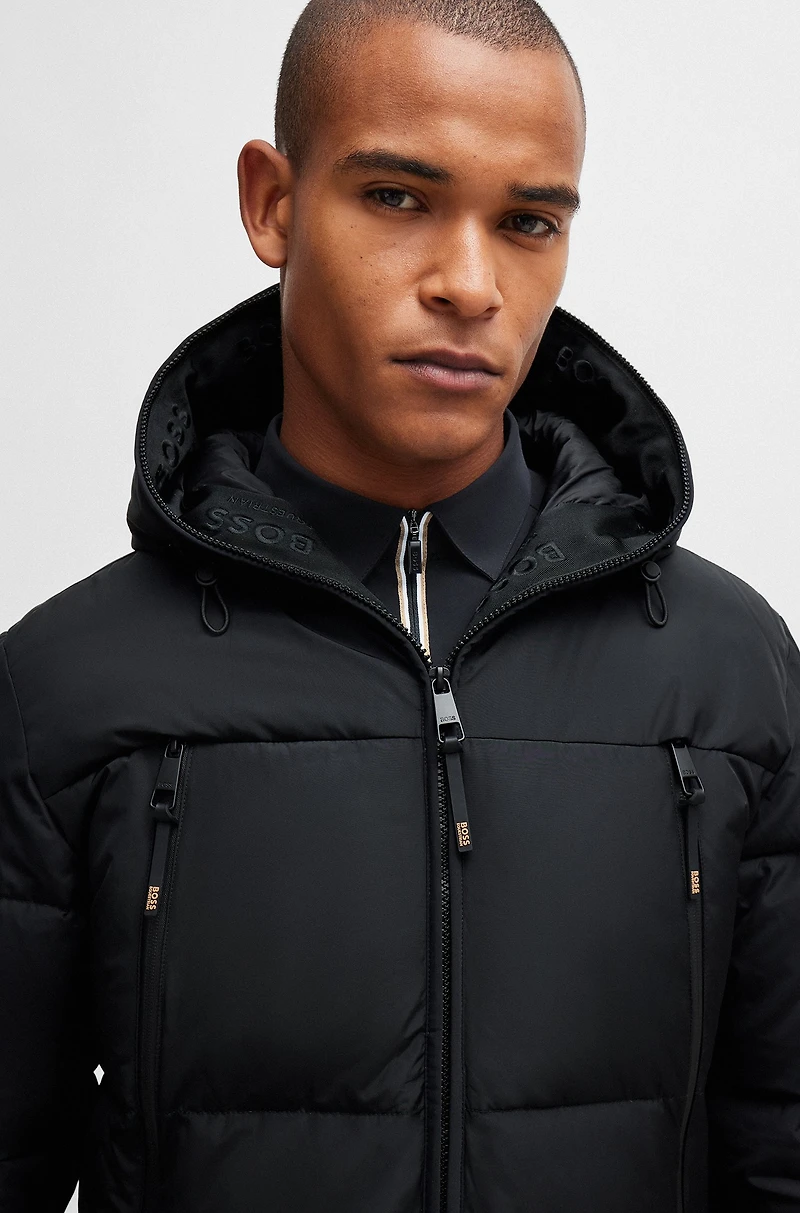 Equestrian hooded puffer jacket with fleece-lined pockets