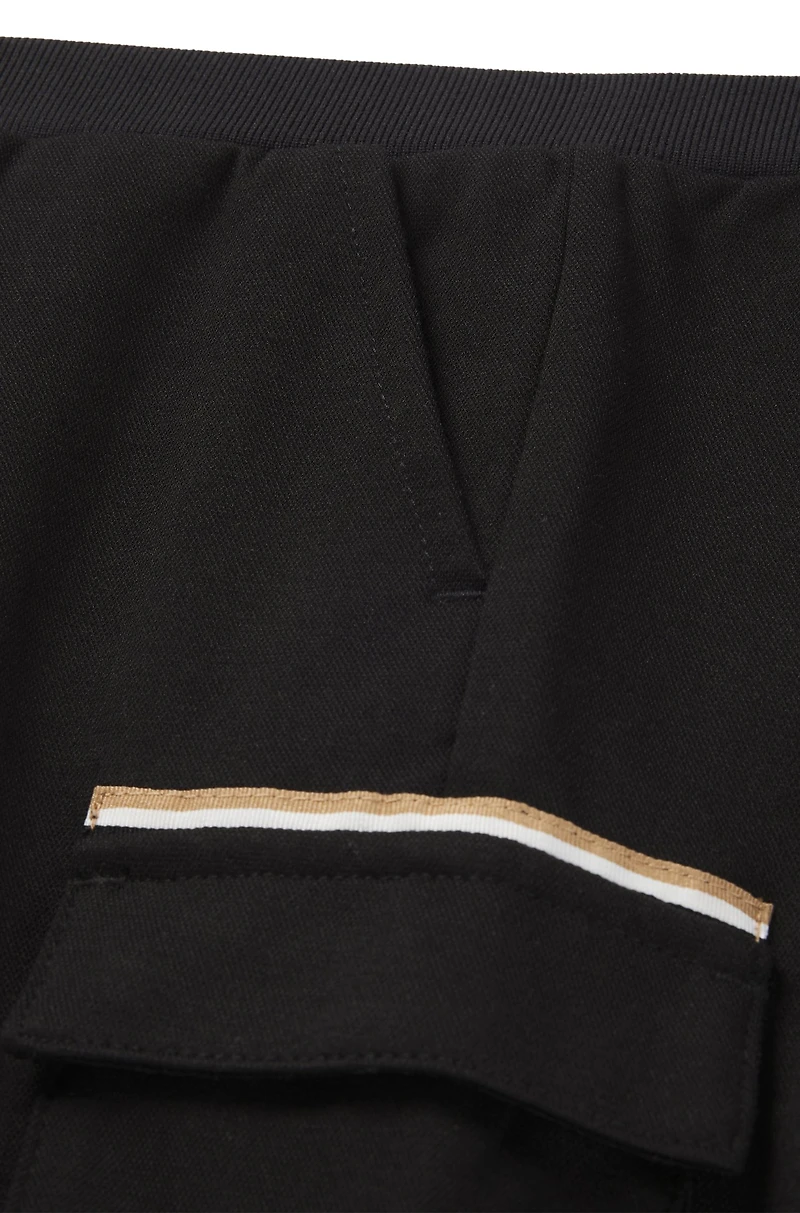 Kids' cargo trousers stretch piqué with logo label