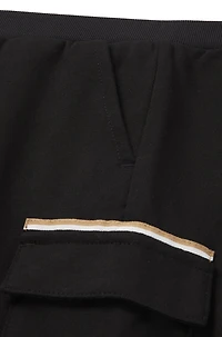 Kids' cargo trousers stretch piqué with logo label