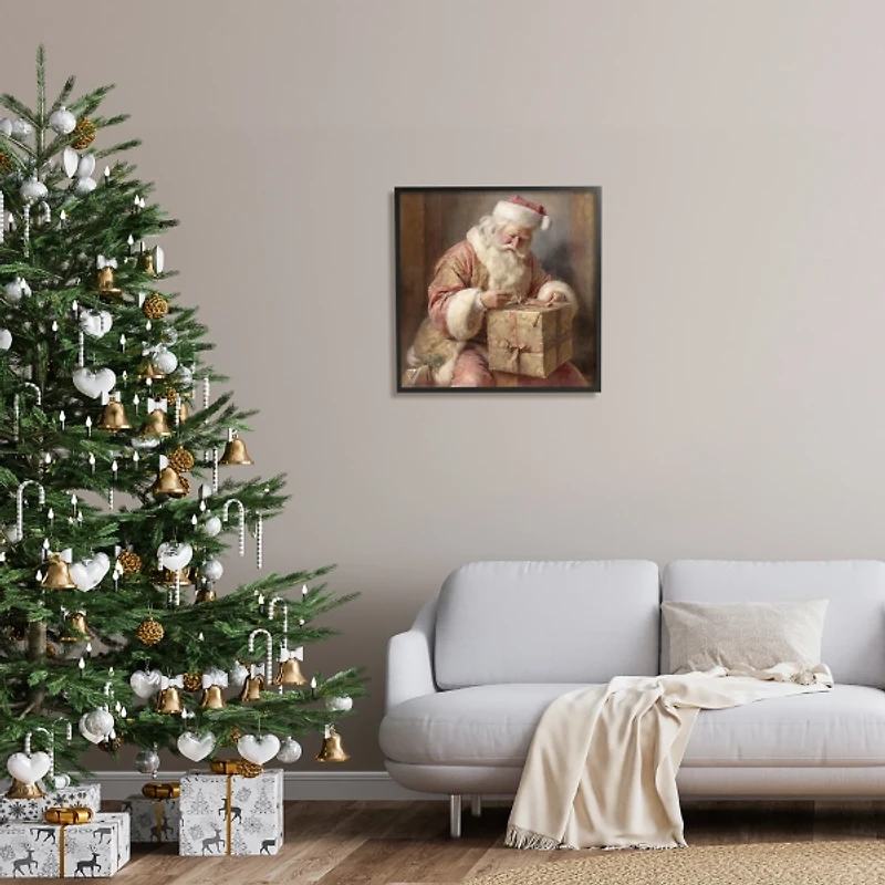 Santa Wrapping a Gift Framed Art Print