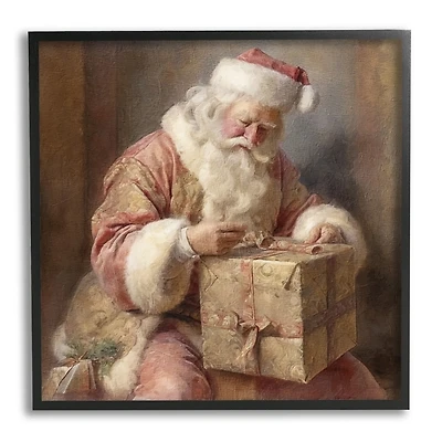 Santa Wrapping a Gift Framed Art Print