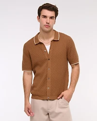 Polo estilo suéter abotonado con pespuntes de diamantes