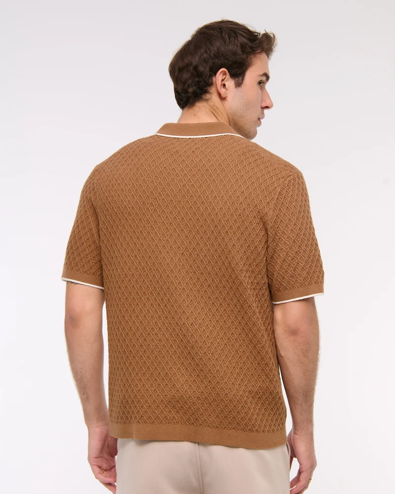 Polo estilo suéter abotonado con pespuntes de diamantes
