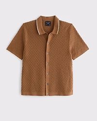 Polo estilo suéter abotonado con pespuntes de diamantes