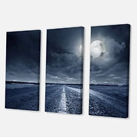 Designart - Asphalt Road Under Cloudy Full Moon I