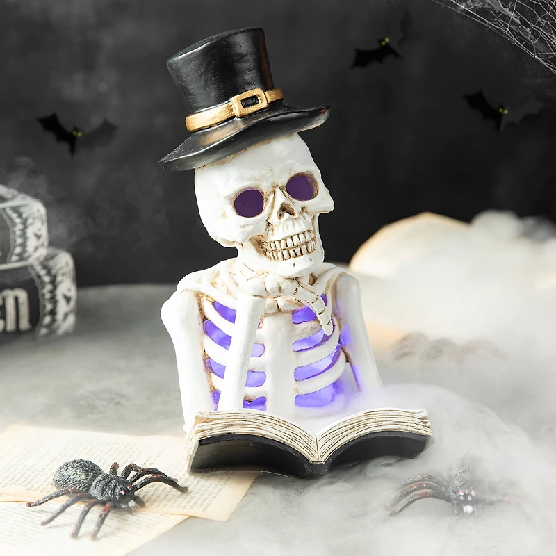 Glitzhome® 10" Lighted Halloween Resin Skull Reading Book Table Décor