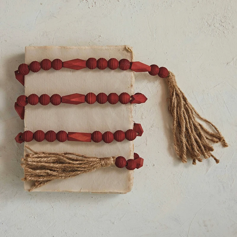 Hello Honey® 6ft. Burgundy Paulownia Wood Beads & Jute Tassels Garland