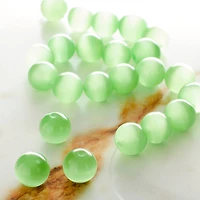 12 Pack: Peridot Cat's Eye Glass Round Beads, 10mm by Bead Landing™