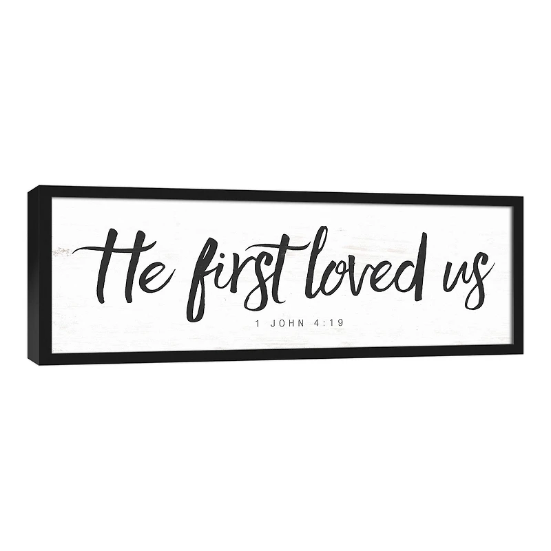He First Loved Us 37.73" x 13.73" Black Framed Canvas