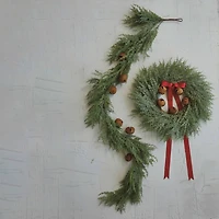 Hello Honey® 24" Round Mixed Pine Wreath with Red Ribbon & Rust Finish Metal Bells