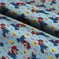 Nintendo® Mario Mushroom Light Blue Toss Cotton Fabric