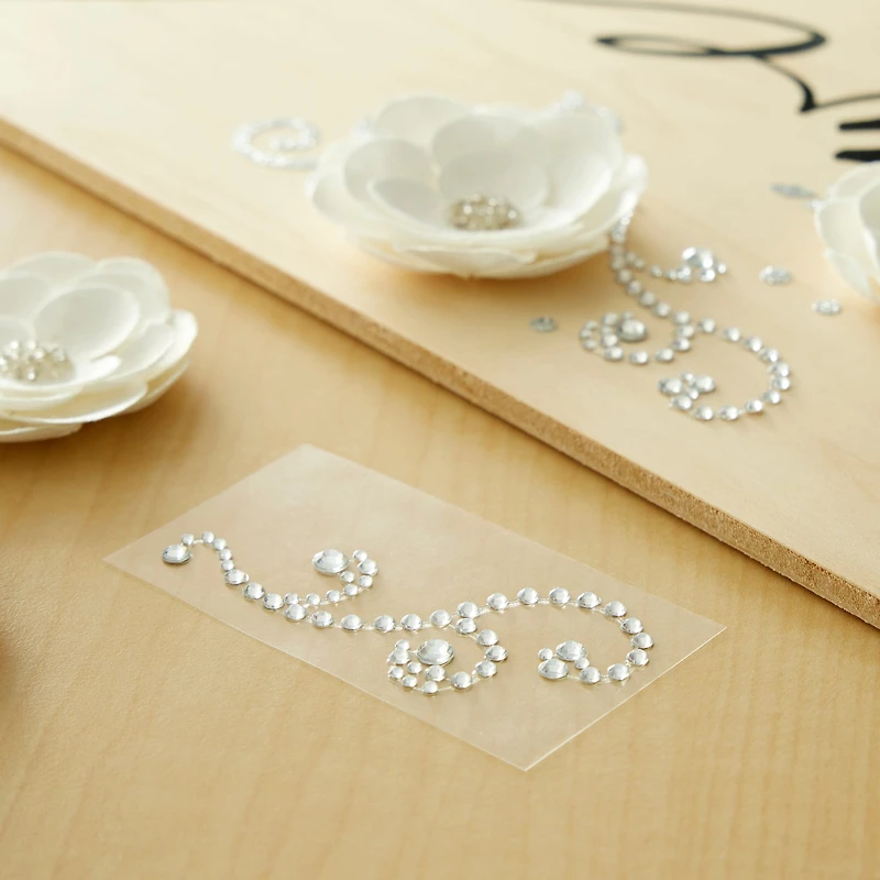 12 Packs: 4 ct. (48 total) Clear Swirl Flourish Adhesive Rhinestones by Recollections™