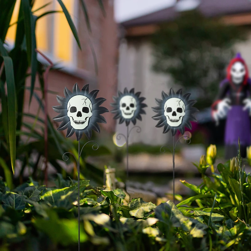 Glitzhome® 24" Halloween Metal Sunflower Skulls Glow-in-Dark Yard Stakes, 3ct.