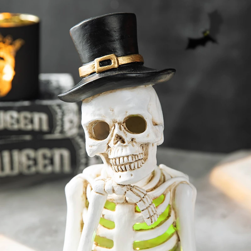 Glitzhome® 10" Lighted Halloween Resin Skull Reading Book Table Décor