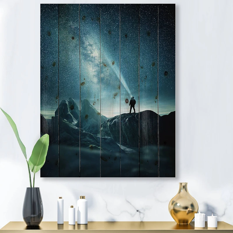 Designart - A Man Shining A Light Into The Night Sky - Modern Print on Natural Pine Wood