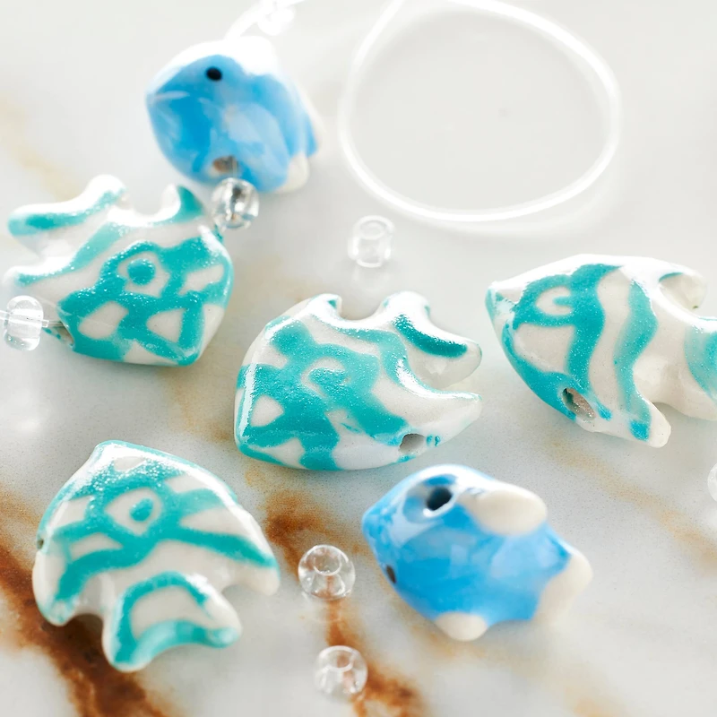 12 Packs: 8 ct. (96 total) Blue Fish Mix Ceramic Beads by Bead Landing™