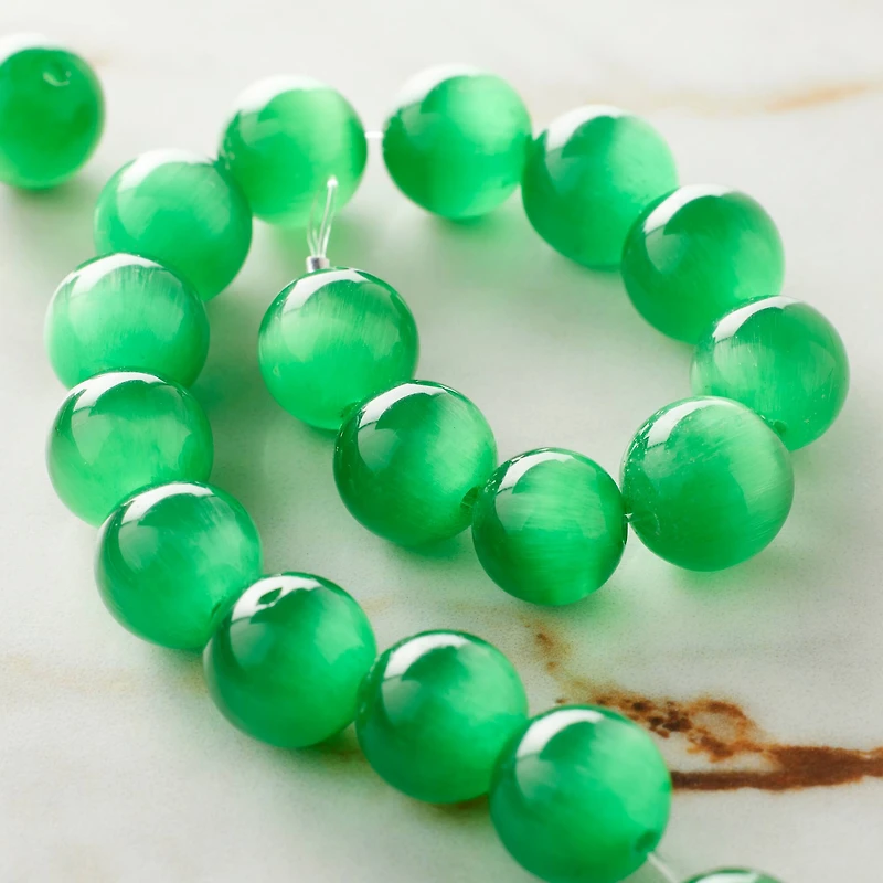12 Packs: 22 ct. (264 total) Emerald Green Cat's Eye Glass Round Beads, 10mm by Bead Landing™