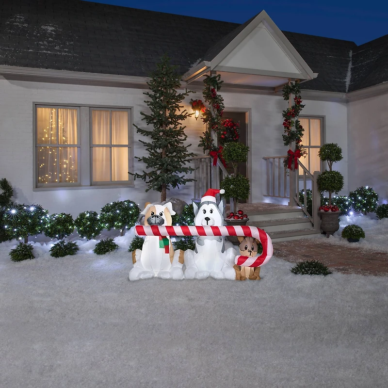 5.5ft. Airblown® Inflatable Christmas Puppies with Big Candy Cane