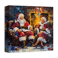 Santa and Mrs. Claus Cozy Fire 12" x 12" Canvas Wall Art