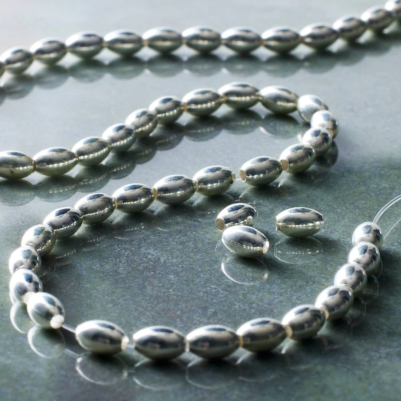 12 Pack:  Silver Metal Small Oval Beads, 6mm by Bead Landing™