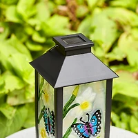 Glitzhome® 11" Glass with Butterfly & Flower Pattern Solar Powered Hanging Lanterns, 2ct.