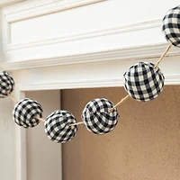 Glitzhome® 6ft. Black & White Plaid Fabric Garland