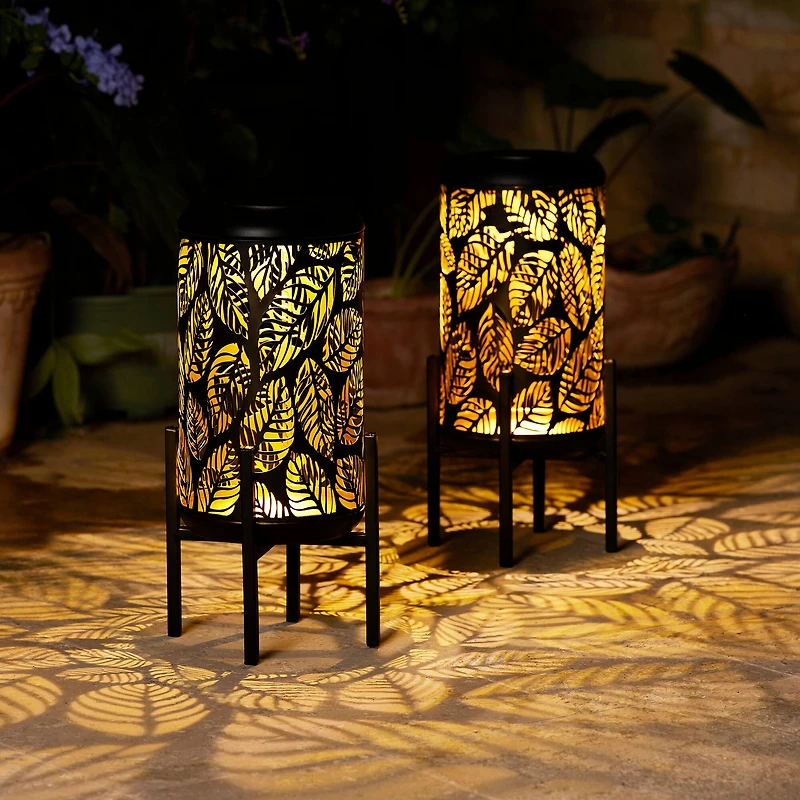 Glitzhome® 14.25" Black Metal Cutout Leaves Pattern Solar Powered LED Outdoor Lantern, 2ct.